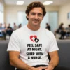 Man wearing a white Feel Safe At Night Sleep with a Nurse Men T Shirt sitting in a waiting room