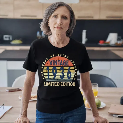 Older woman wearing a black ladies 90th birthday T shirt with “90 Years of Being Awesome” design