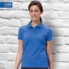 Woman wearing a QUOZ ladies polo shirt in royal blue, classic cotton pique polo suitable for everyday wear