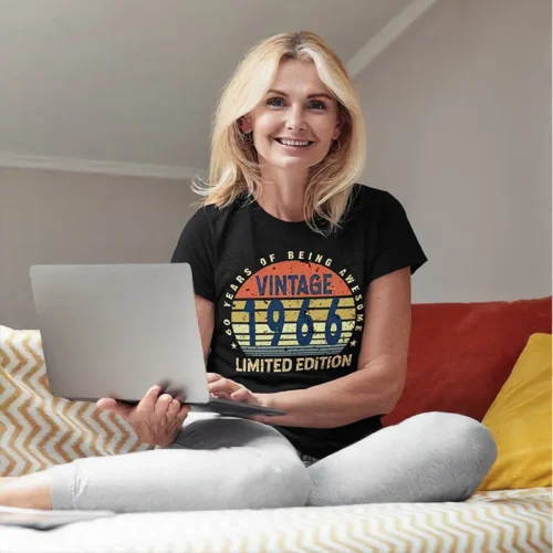 Middle-aged woman wearing a black ladies 60th birthday T shirt with “60 Years of Being Awesome” design