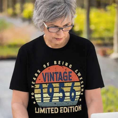 Older woman wearing a black ladies 70th birthday T shirt with “70 Years of Being Awesome” design