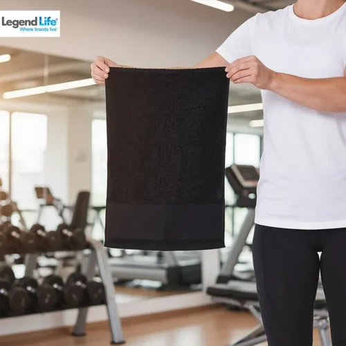 Legend Life Basic Gym Towel in Black with custom print, lifestyle close-up, gym background