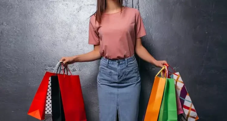 Stay at home mum starting a t-shirt business from home on laptop