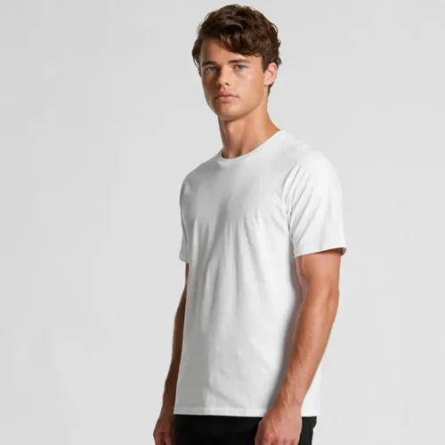 Custom printed bulk AS Colour Staple white T-shirts angled view White AS Colour Staple T-shirt angled front view on model Natural pose showing premium fit and fabric drape Clean blank surface ready for custom printing Ideal for visualising finished printed garment