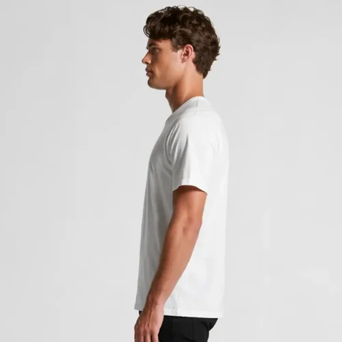 Custom printed bulk AS Colour Staple white T-shirts side view White AS Colour Staple T-shirt side profile on model Shows garment structure and sleeve length Premium fit with clean side seam Demonstrates shape and overall wearability