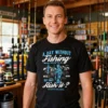 Man wearing a distressed A Day Without Fishing black t-shirt in a tackle shop