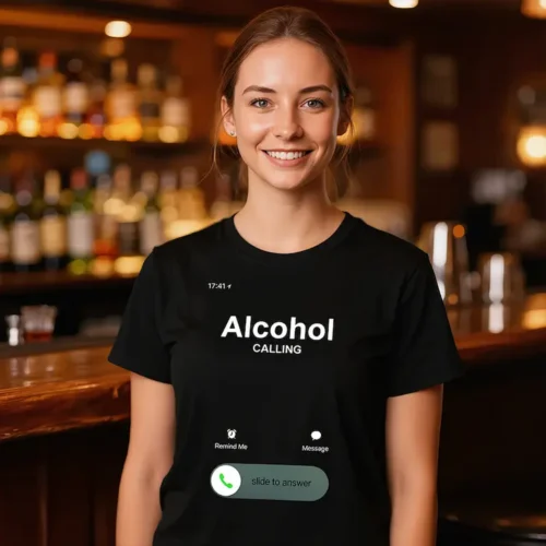 Woman wearing an Alcohol Is Calling black t-shirt in a bar