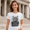 Woman wearing a white Bad Kitty t-shirt in front of a courthouse