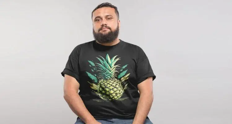 Man wearing a black big fit custom printed t shirt with a pineapple design