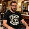 Man wearing the Classic Barber Shop men’s t-shirt in black while sitting in a barber’s chair