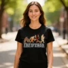 Woman wearing the Evolution of a Man ladies t-shirt in black while standing in a park