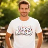 Man wearing the Happy Birthday men’s t-shirt in white while standing in a park