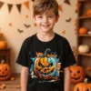 Boy wearing a black Jack O Lantern Pumpkin Kids T Shirt standing in a lounge room decorated for a party