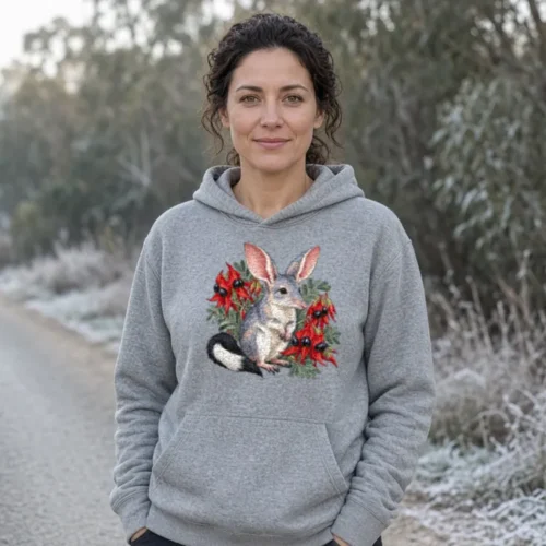 Lifestyle photo of the Bilby Among Sturt Desert Peas Hoodie being worn or used
