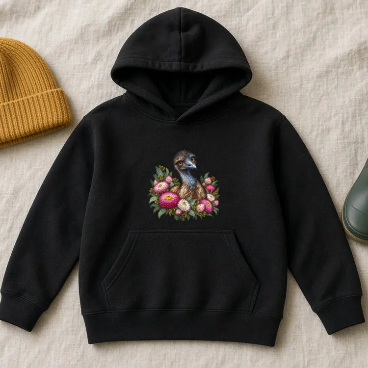 Black Elegant Emu with Everlasting Daisies kids hoodie laid flat on pale linen beside a mustard knitted beanie and a green gumboot