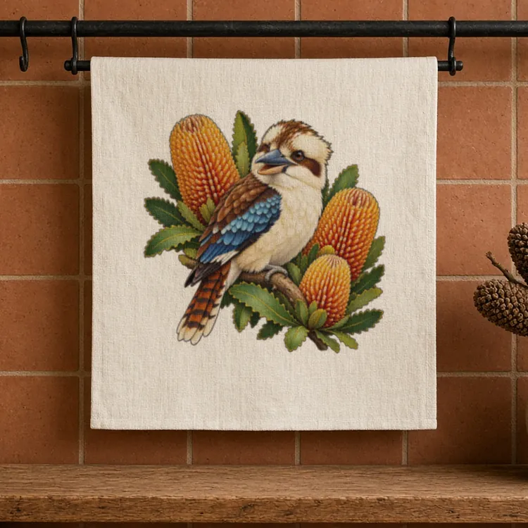 Flax Kookaburra with Golden Banksia tea towel hanging from a black iron pot rack bar against a terracotta tiled wall