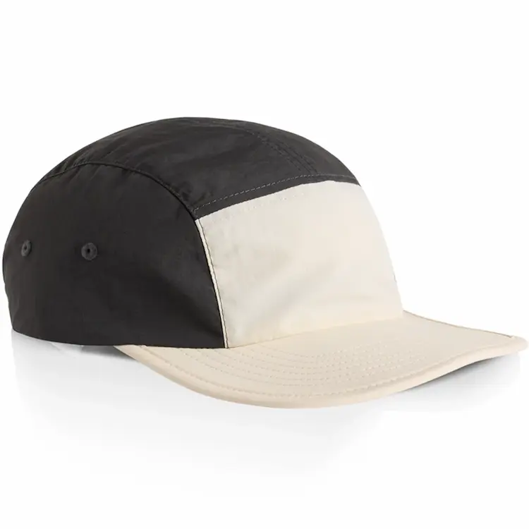 Side view of the Ecru/Coal AS Colour Finn Two-Tone Nylon Cap showing contrasting panels and side eyelets