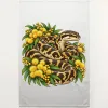 Natural linen tea towel printed with a carpet python among golden wattle