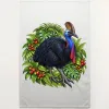 Natural tea towel printed with a cassowary among rainforest leaves and red fruit