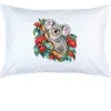 White pillow case printed with a koala among coral-red eucalyptus blossom